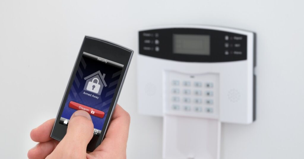 Homeowner arming a security system.