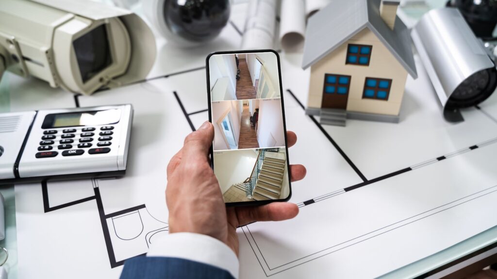 Person looking at home surveillance on a phone, surrounded by other security options.