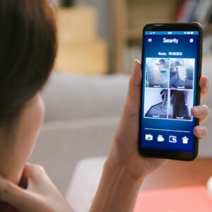 a woman looking at a security system on her phone