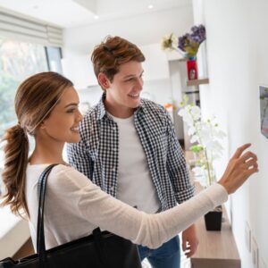 a young couple setting their home security system