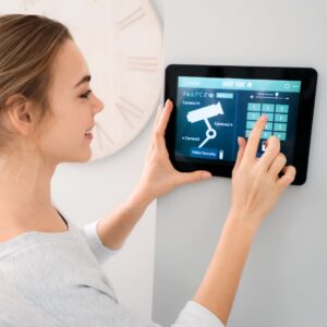 woman updating a smart alarm system. 