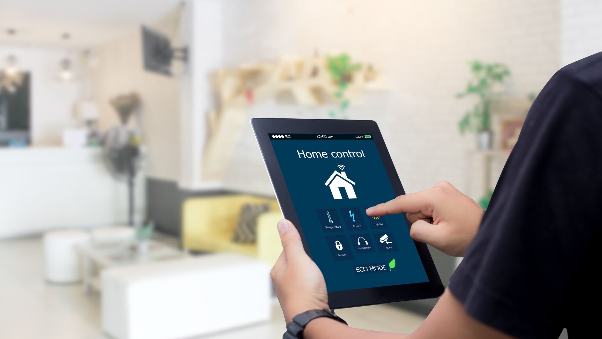 man using a tablet to access his smart home system.