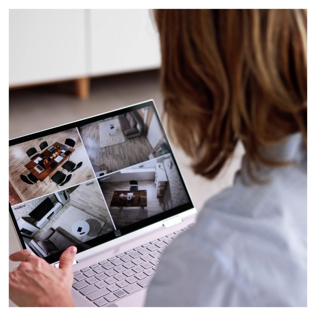 woman watching security footage on laptop