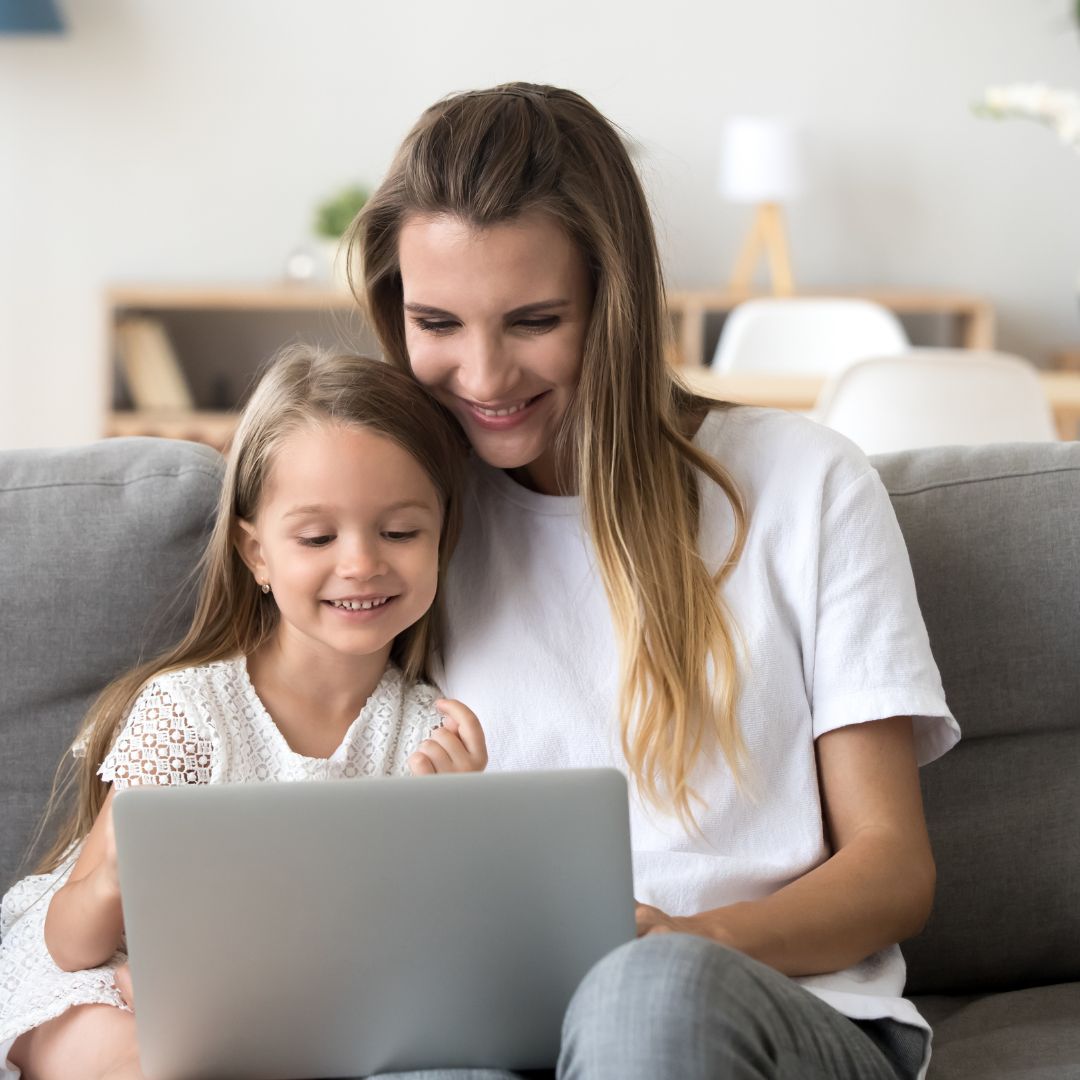 mom and daughter looking at computer