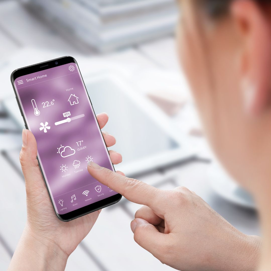 person using their home security app on their phone