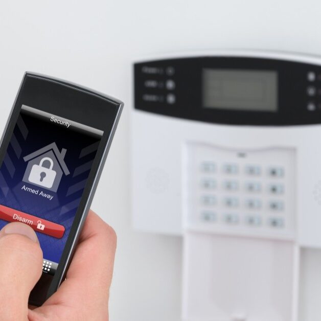 Homeowner arming a security system.